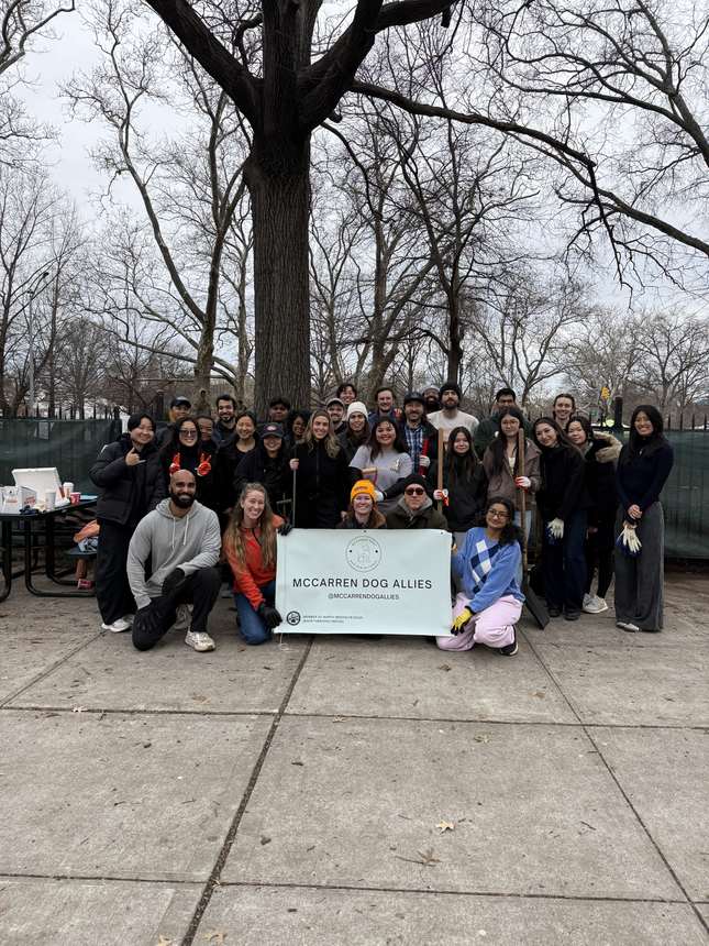 A large group of volunteers posing together after a park clean-up