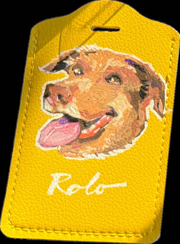 A hand-painted portrait of a dog named Rolo on a yellow leather case, painted live at Run Club by Ben Silbers